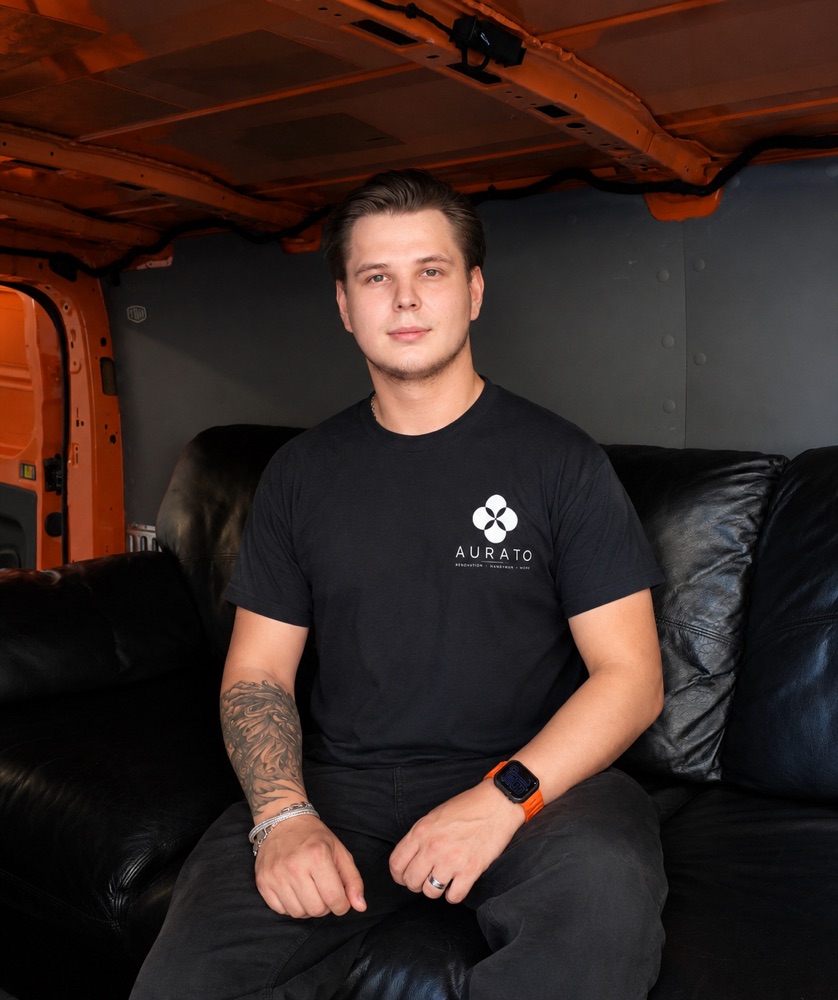 Oleh Kaskiv, founder of Aurato, sitting in the company work van